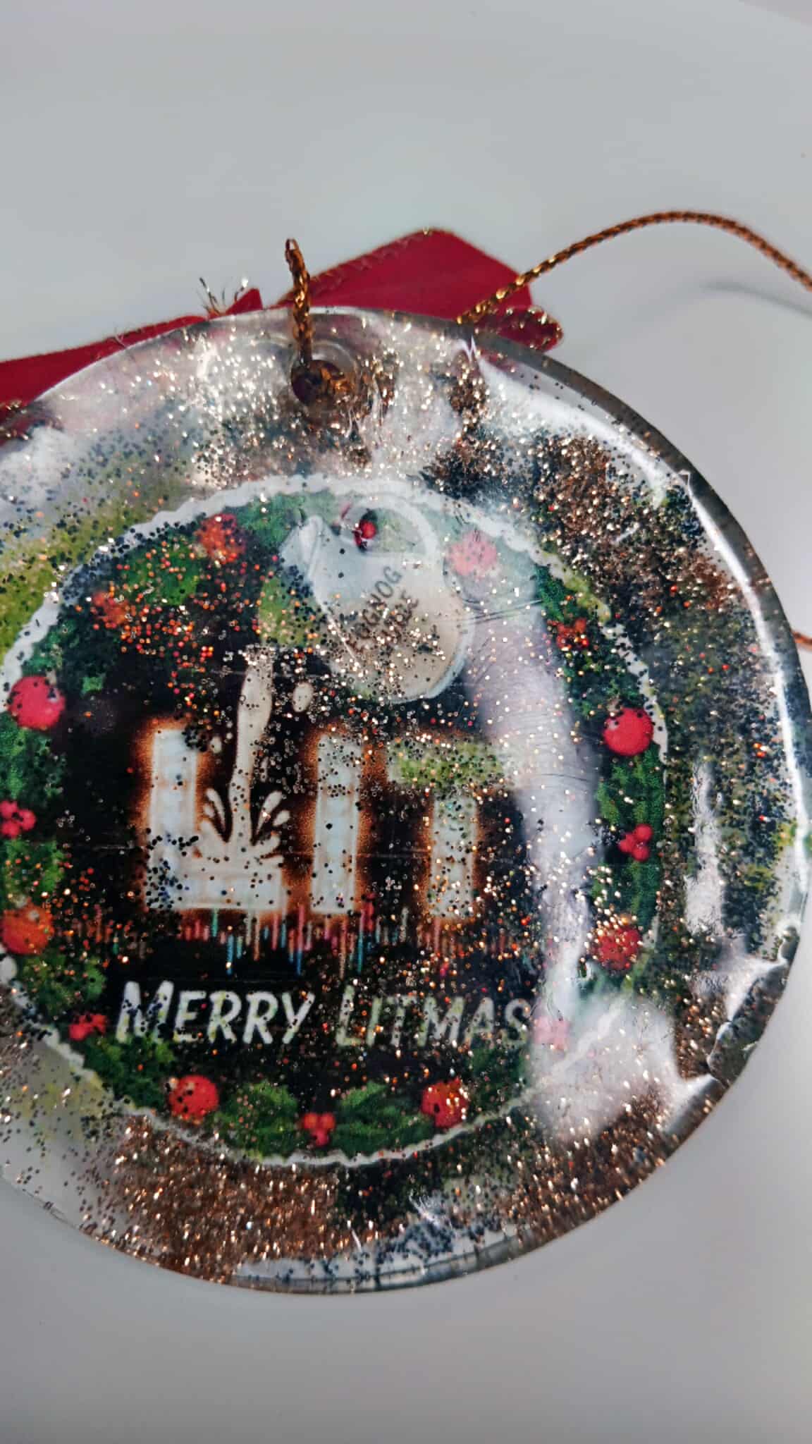 Decorative Christmas ornament with 'Merry LItmas' text on a white background