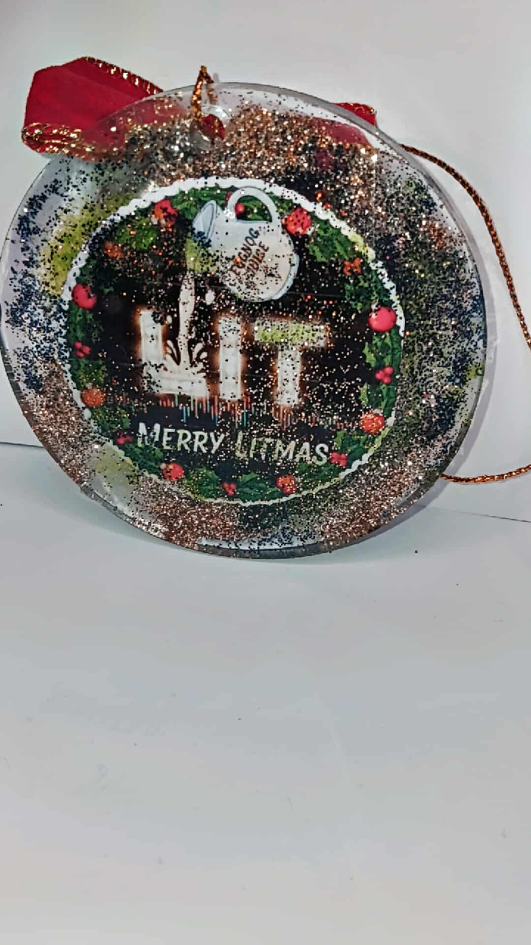 Decorative Christmas ornament with 'Merry Litmas' text on a white background